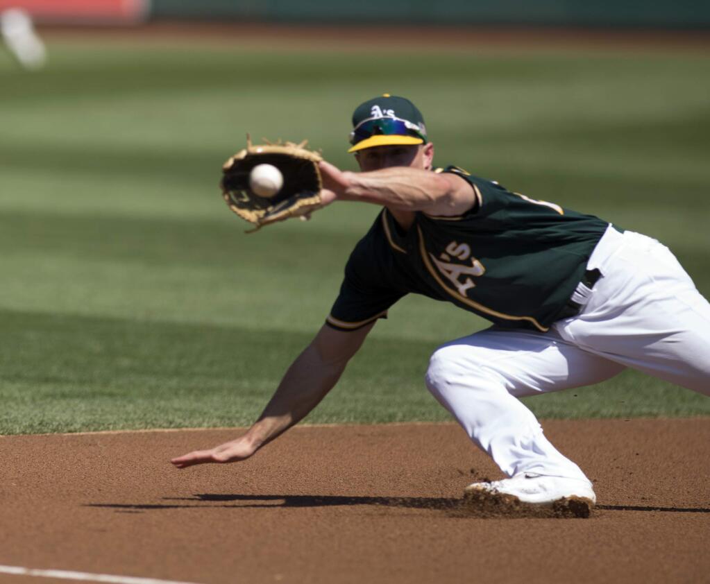 Oakland Athletics' Matt Chapman (26) dives in vain for a double by Houston Astros' Jose Altuve during the first inning of a baseball game, Sunday, Sept. 10, 2017, in Oakland, Calif. (AP Photo/D. Ross Cameron)