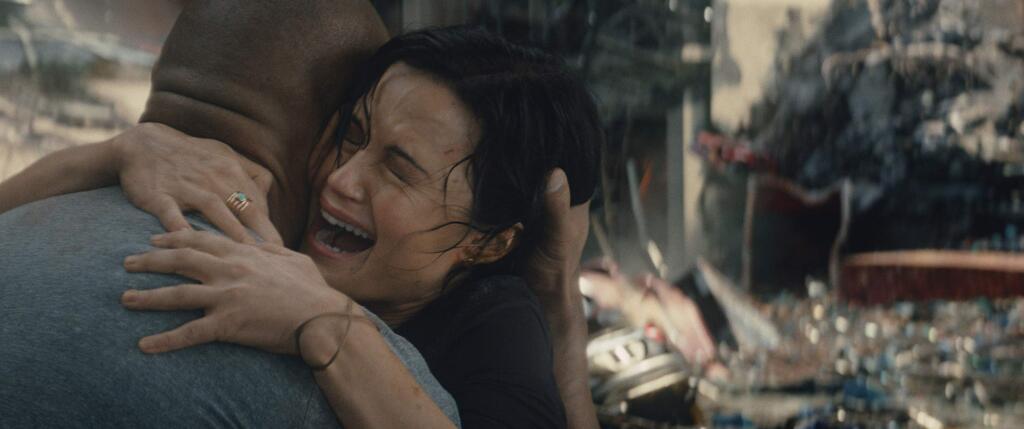 This photo provided by Warner Bros. Pictures shows Dwayne Johnson, left, as Ray, and Carla Gugino as Emma, in a scene from the action thriller, 'San Andreas.' The movie releases in theaters on May 29, 2015. (Courtesy Warner Bros. Pictures via AP)