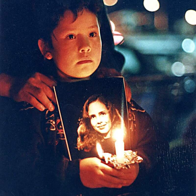 Lizeth Lopez holds a candle and photo of Polly Klaas at a vigil outside the Polly Klaas Search Center in Petaluma on Saturday night December 4th 1993, after is was announced that Polly Klaas's body was found.