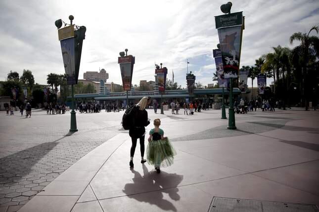 Visitors arrive at the main entrance to the Disney theme parks, Thursday, Jan. 22, 2015, in Anaheim. The outbreak will be declared over in California on Friday if no new cases pop up, according to the California Department of Public Health. (AP Photo/Jae C. Hong)