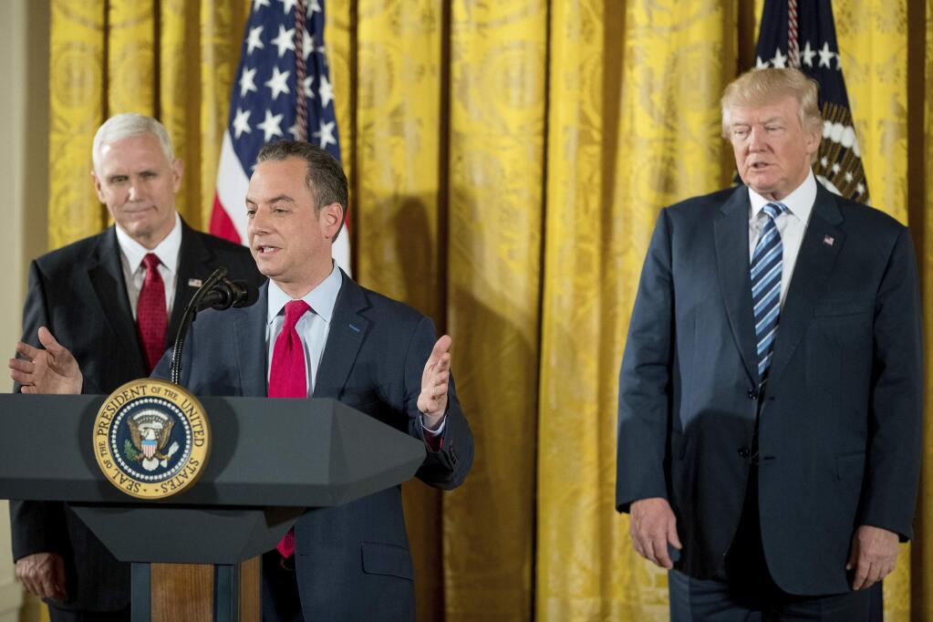 Trump Chief of Staff Reince Priebus, second from left, accompanied by Vice President Mike Pence, left, and President Donald Trump, right, speaks during a White House senior staff swearing in ceremony in the East Room of the White House, Sunday, Jan. 22, 2017, in Washington. (AP Photo/Andrew Harnik)