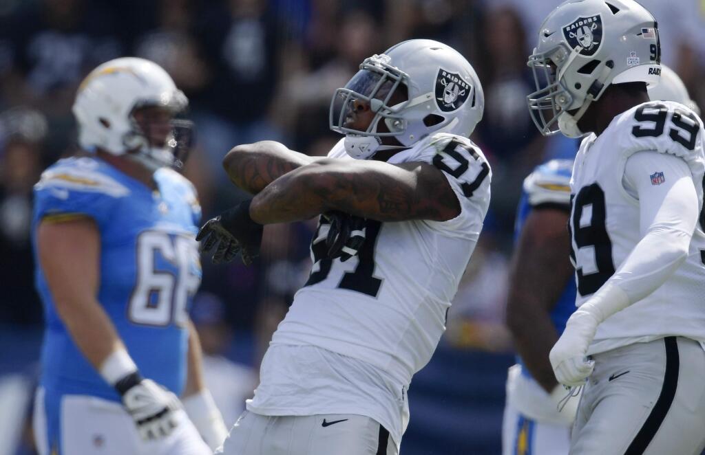 In this Oct. 7, 2018, file photo, Oakland Raiders defensive end Bruce Irvin, center, reacts after sacking Los Angeles Chargers quarterback Philip Rivers during the first half in Carson. Irvin and the Raiders play the Seattle Seahawks this week in London. Irvin won a Super Bowl with Seattle. (AP Photo/Mark J. Terrill, File)