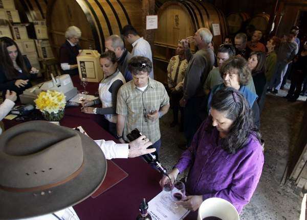 News/--At A. Rafanelli Winery in Dry Creek, visitors to the Russian River Wine Road barrel tasting event sample wines, Saturday March 7, 2009. (Kent Porter / The Press Democrat)2009