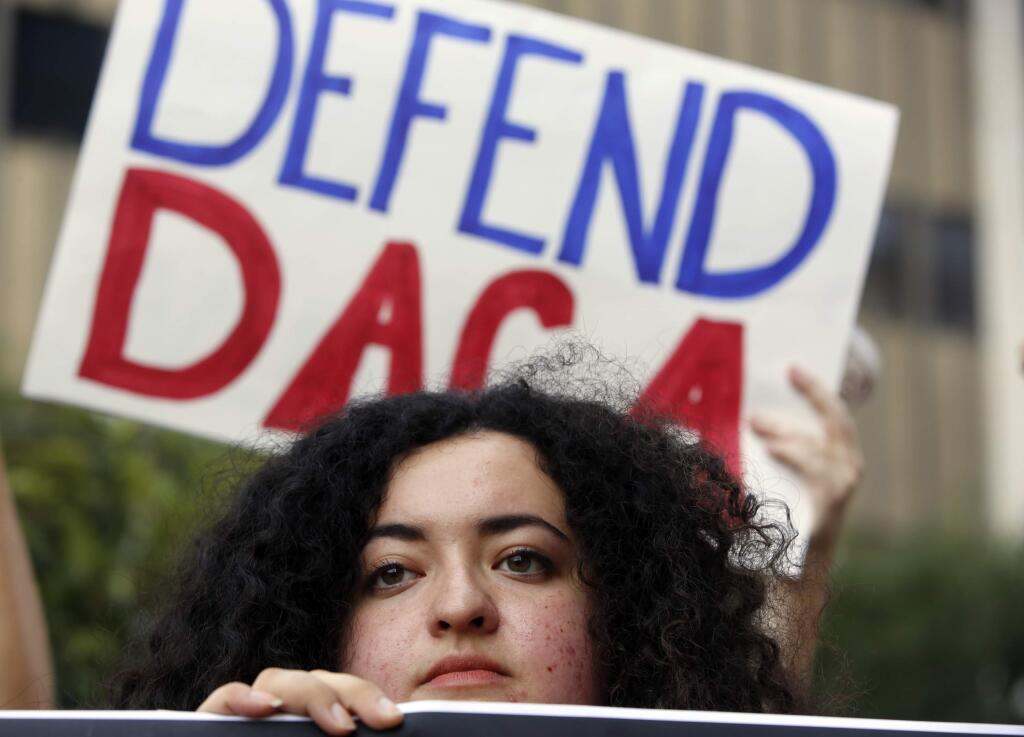 FILE - In this Sept. 1, 2017 file photo, Loyola Marymount University student and dreamer Maria Carolina Gomez joins a rally in support of the Deferred Action for Childhood Arrivals, or DACA program, outside the Edward Roybal Federal Building in Los Angeles. (AP Photo/Damian Dovarganes, File)