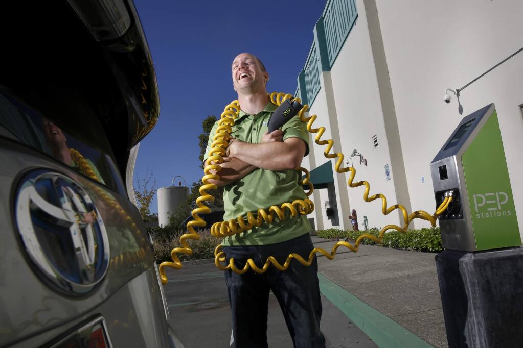 Mark Gmelin, a Materials R&D Engineer and Sustainability Coordinator, stands at one the company's solar powered electric car charging stations for employees at Labcon North America on Wednesday, September 2, 2015 in Petaluma, California . (BETH SCHLANKER/ The Press Democrat)