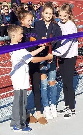 JOHN JACKSON/ARGUS-COURIER STAFFNicholas Johnson, Katrina Johnson, Anna Skoff and Julia Skoff cut the ribbon on Petaluma High School's new field and track. The track was officially named for their grandfather, track coach Doug Johnson. The press box was named in honor of the late Ron Walters.