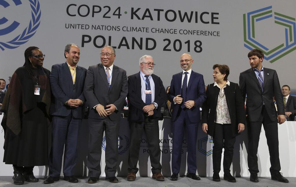 Heads of the delegations react at the end of the final session of the COP24 summit on climate change in Katowice, Poland, Saturday, Dec. 15, 2018.(AP Photo/Czarek Sokolowski)