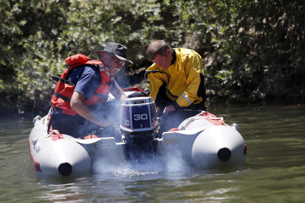 Monte Rio fire officials search for the body of a missing man in his early 20s just downstream from Monte Rio Beach at the on Saturday, July 4, 2015 in Monte Rio, California . (BETH SCHLANKER/ The Press Democrat)