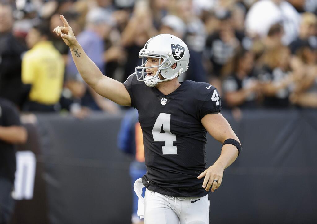 Oakland Raiders quarterback Derek Carr (4) celebrates after throwing a touchdown pass against the Los Angeles Rams during the first half of an NFL preseason football game in Oakland, Saturday, Aug. 19, 2017. (AP Photo/Ben Margot)