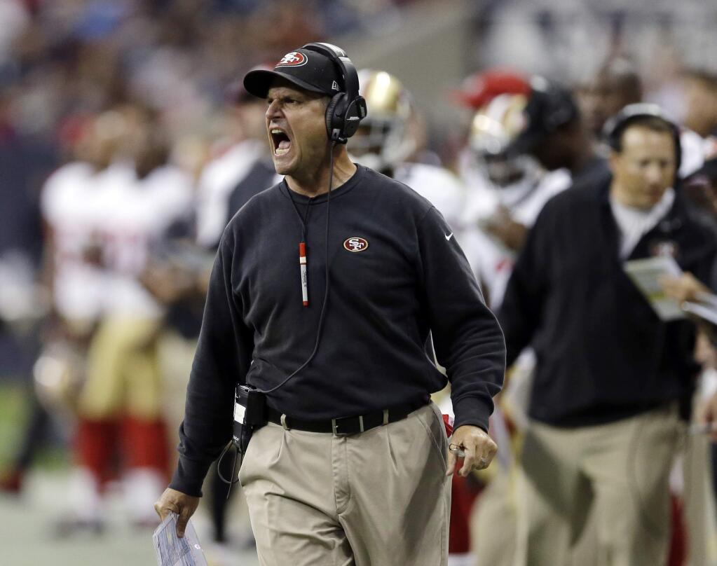 San Francisco 49ers head coach Jim Harbaugh calls from the sidelines during the first quarter of an NFL football preseason game against the Houston Texans, Thursday, Aug. 28, 2014, in Houston. (AP Photo/David J. Phillip)