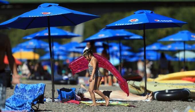 Ayla Uludemir of Sebastopol, 8, finishes up her day of swimming at Johnson's Beach in Guerneville, Monday July 20, 2015. (Kent Porter / Press Democrat) 2015