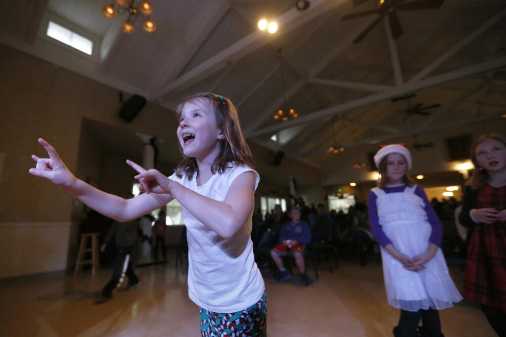 Morgan Sloat, 8, dances to Christmas music during the Holiday Concert for Compassion at The Saturday Afternoon Club on Sunday, December 11, 2016 in Santa Rosa, California . (BETH SCHLANKER/The Press Democrat)