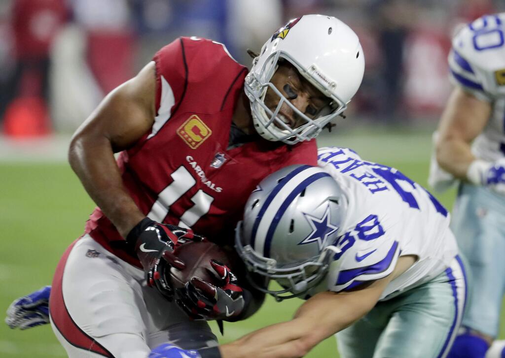 Arizona Cardinals wide receiver Larry Fitzgerald (11) is hit by Dallas Cowboys strong safety Jeff Heath (38) during the first half Monday, Sept. 25, 2017, in Glendale, Ariz. (AP Photo/Rick Scuteri)