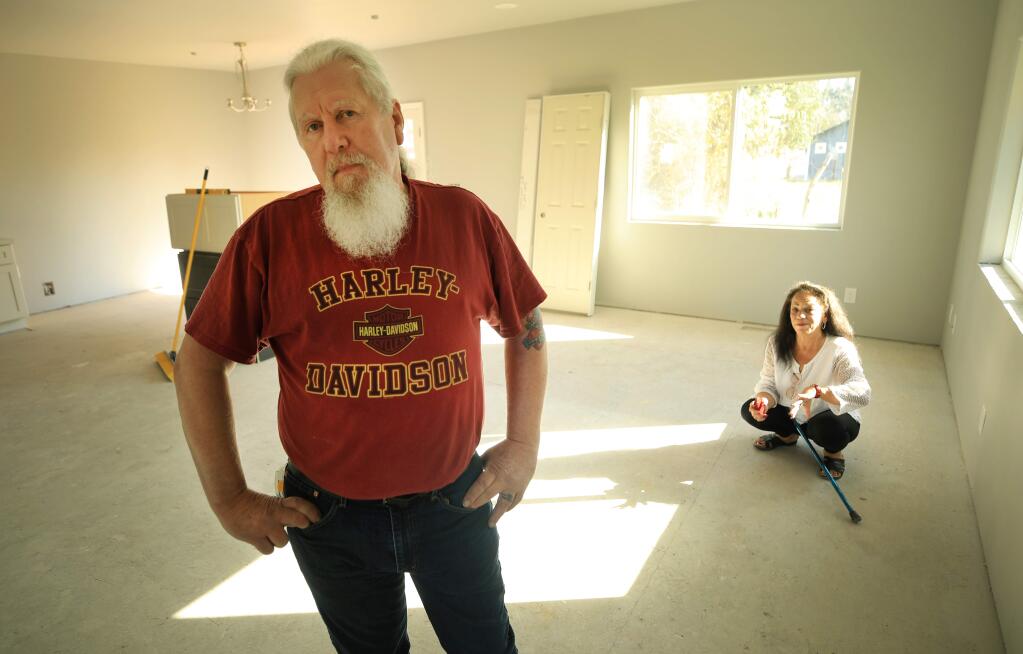 Keith and Beatrice Caldwell in the living room of their new home being rebuilt after the 2017 Tubbs fire and had a nightmare experience with their contractor who has done subpar incomplete work, Wednesday, March 11, 2020. (Kent Porter / The Press Democrat) 2020