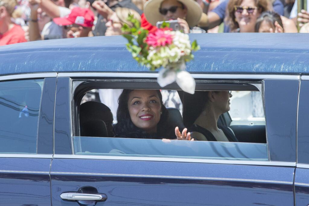 Hana Ali, daughter of Muhammad Ali, is throw flowers as she rides in her father's funeral procession while it enters Cave Hill Cemetery, Friday, June 10, 2016, in Louisville, Ky. (AP Photo/John Minchillo)