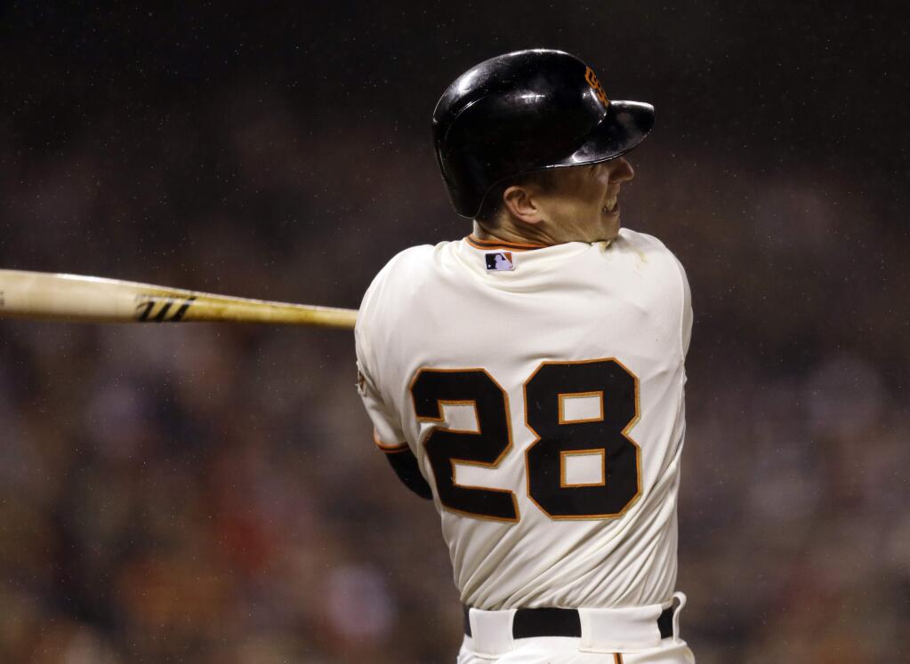 San Francisco Giants' Buster Posey swings for a double off Los Angeles Dodgers' Brett Anderson in the sixth inning of a baseball game Wednesday, May 20, 2015, in San Francisco. (AP Photo/Ben Margot)