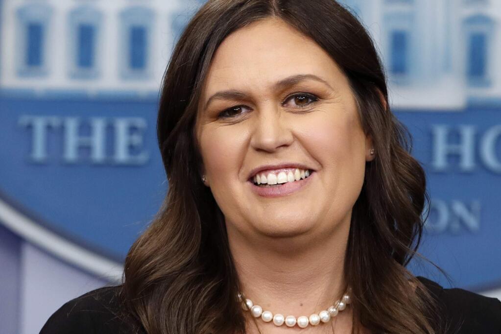 FILE - In this June 14, 2018 file photo, White House Press Secretary Sarah Huckabee Sanders smiles as she wishes President Donald Trump a happy birthday, during the daily briefing, in the Briefing Room of the White House in Washington. Sanders acknowledges in a tweet that she was asked to leave a Virginia restaurant Friday night, June 22. Sanders said she was told by the owner of The Red Hen in Lexington, Virginia, that she had to 'leave because I work for @POTUS and I politely left.' Sanders' treatment at the restaurant has created a social media commotion with people on both sides weighing in to provide their critique of the incident. (AP Photo/Jacquelyn Martin, File)