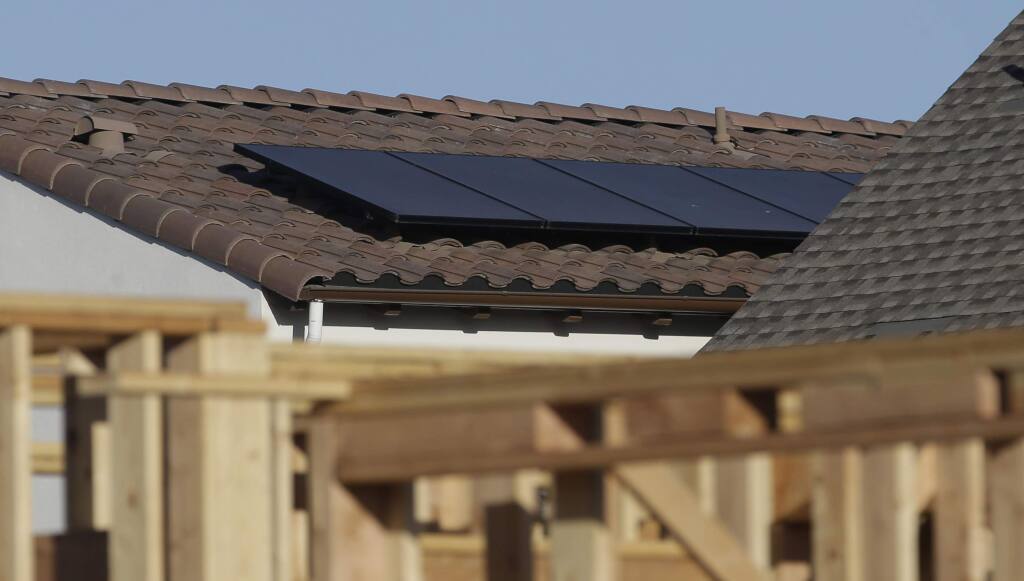 FILE--In this photo file taken Monday, May 7, 2018, solar panels are seen on the rooftop on a home in a new housing project in Sacramento, Calif. (AP Photo/Rich Pedroncelli, file)