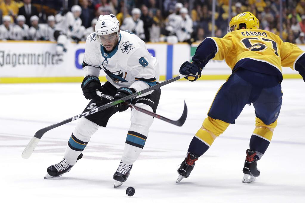 San Jose Sharks left wing Evander Kane (9) battles for the puck with Nashville Predators defenseman Dante Fabbro (57) during the first period of an NHL hockey game Tuesday, Oct. 8, 2019, in Nashville, Tenn. (AP Photo/Mark Humphrey)