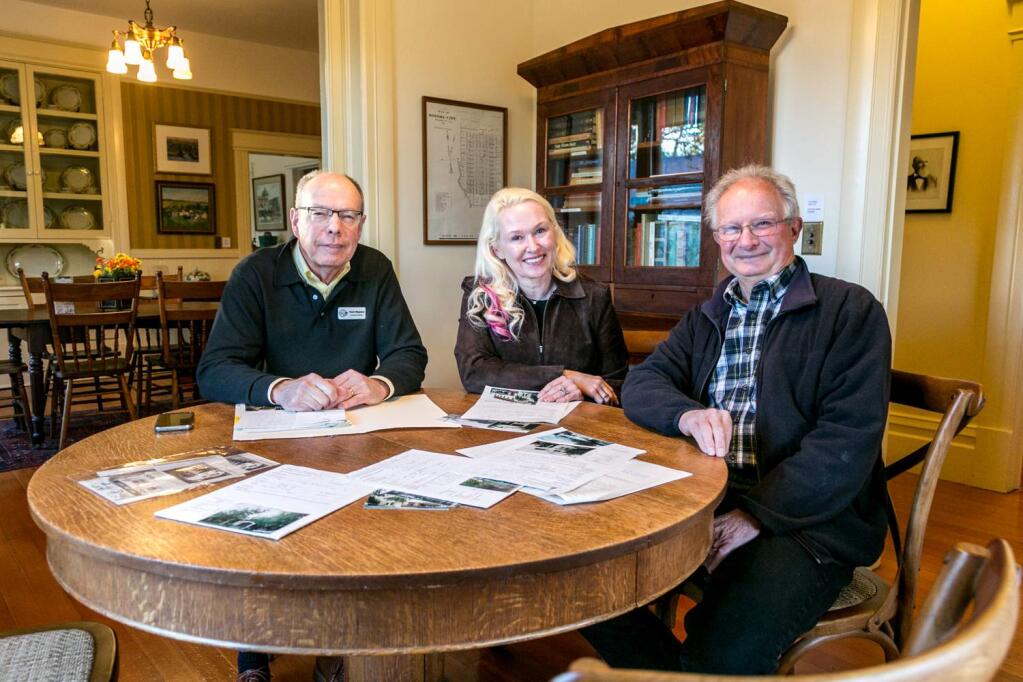 Sonoma League for Historic Preservation Executive Director Chuck Bingaman (left), Alice Duffee and Gerard Bessat at the table in Masonnave House in Sonoma, worked to put information about historic Sonoma Buildings online and accessible to all. (Photo by Julie Vader/special to the Index-Tribune)