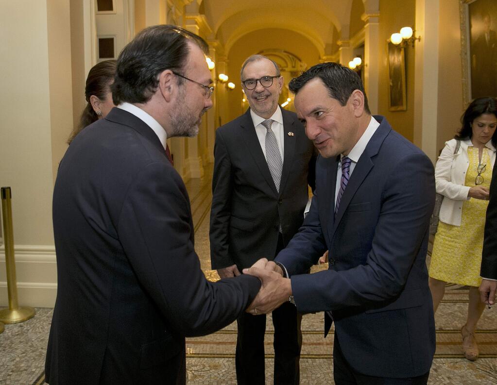 California Assembly Speaker Antony Rendon, D-Paramount, right, shakes hands with Mexican Foreign Relations Secretary Luis Videgaray, left, after their meeting at the Capitol, Monday, Sept. 11, 2017, in Sacramento, Calif. Mexico's top diplomat is making a two-day visit to California which includes a meeting with California Gov. Jerry Brown before traveling to Los Angeles. (AP Photo/Rich Pedroncelli)