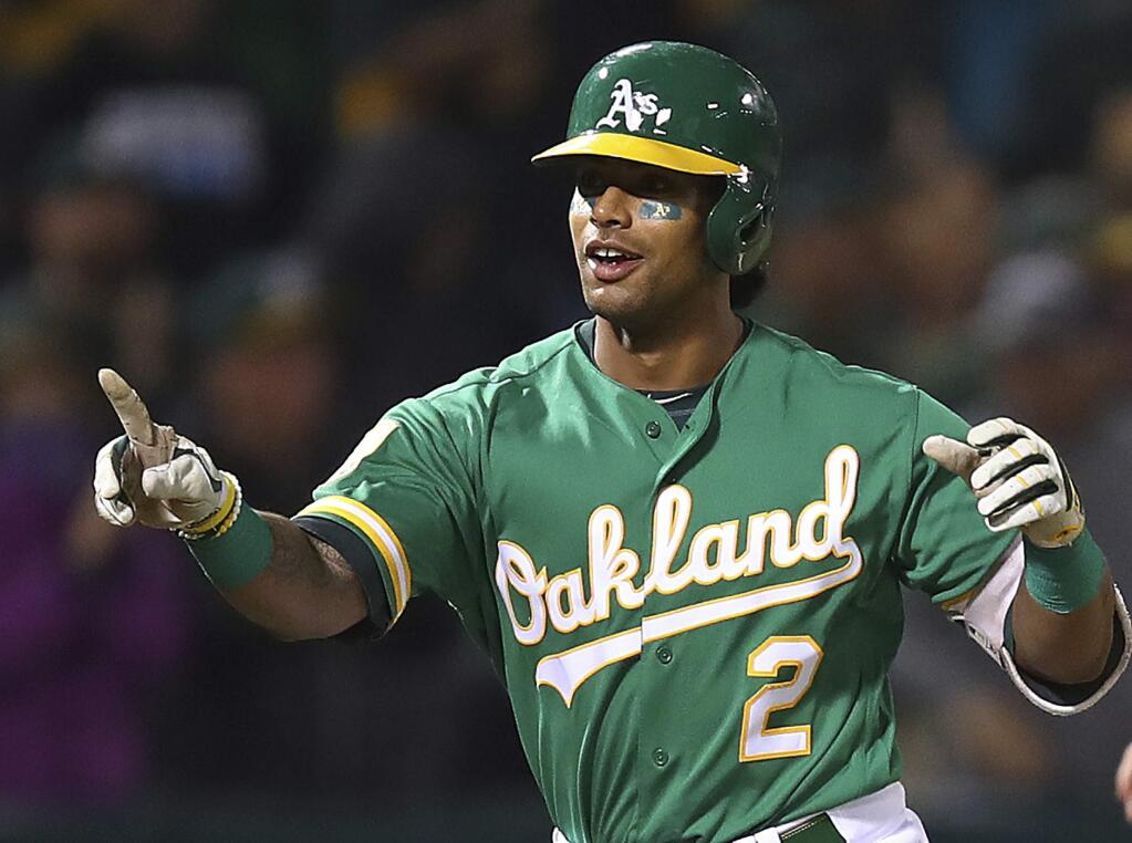 Oakland Athletics Khris Davis celebrates after hitting a walk-off home run in the 10th inning of a baseball game against the Minnesota Twins on Friday, Sept. 21, 2018, in Oakland, Calif. (AP Photo/Ben Margot)