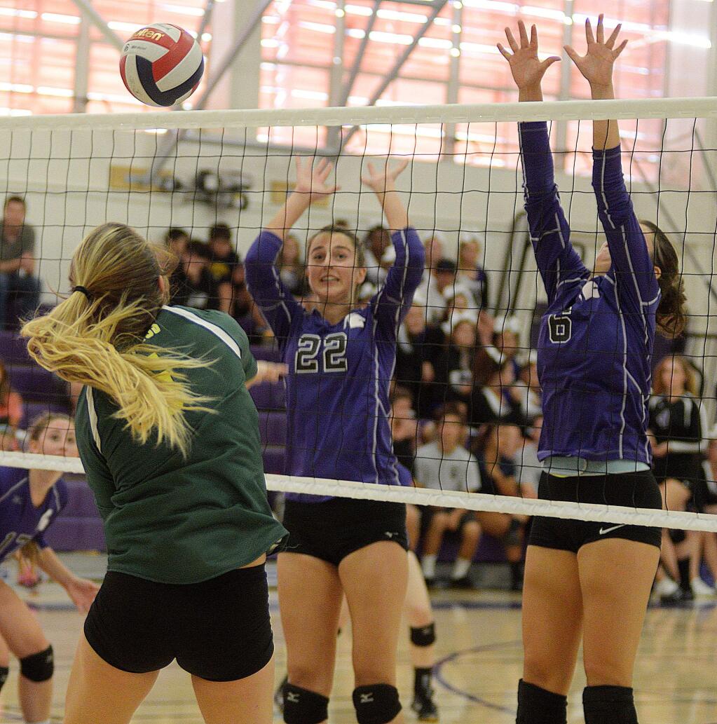 Casa Grande's Makenna Mattei tries to hit the ball over the block of Petaluma's Grace Ghirardelli and Jordan Marshall (6) in a game won by Petaluma, 3-0.(SUMNER FOWLER/FOR THE ARGUS-COURIER)