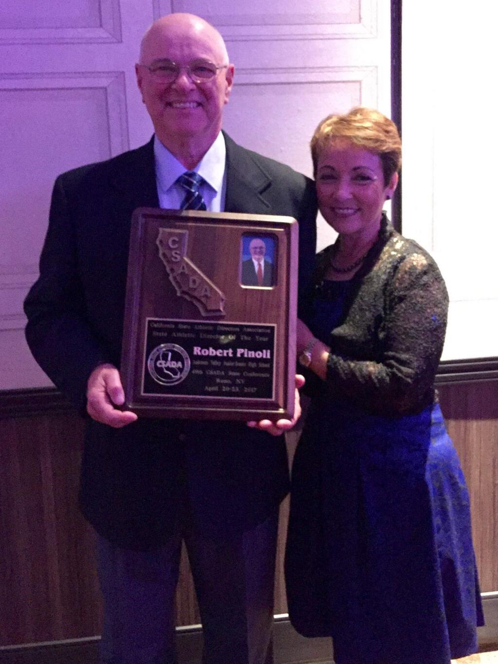 Robert Pinoli and his wife, Cecilia, pose with a plaque recognizing Robert Pinoli as California's Athletic Director of the Year.