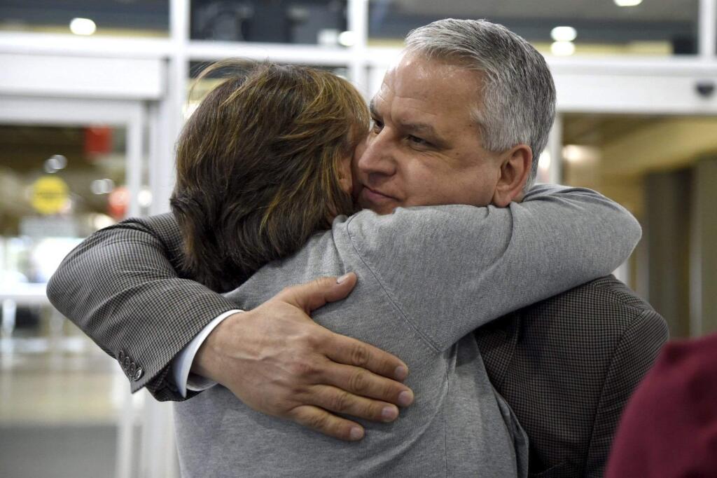 Jim Demetros hugs his wife Cindy as she arrives from their home in Connecticut to pick him at Philadelphia International Airport, Tuesday, April 17, 2018, after his Southwest Airlines plane landed with a damaged engine. The Southwest Airlines jet apparently blew an engine at about 30,000 feet and got hit by shrapnel that smashed a window and damaged the fuselage Tuesday, killing a passenger and injuring seven others, authorities said. (Tom Gralish/The Philadelphia Inquirer via AP)