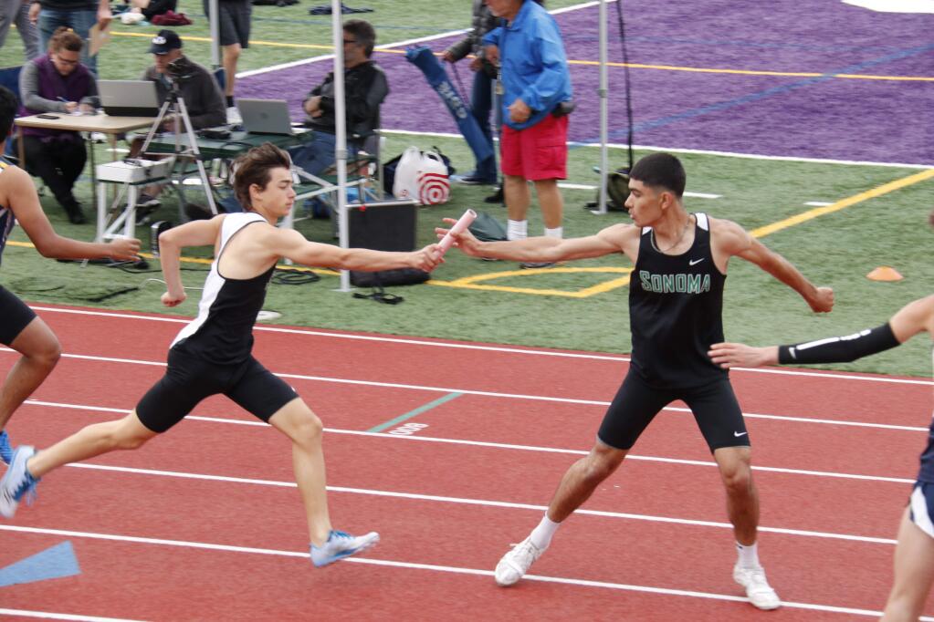 Hunter Belleville handing off the baton to Jesus Robles-Benitez at the 4x400 relay in Petaluma; both the 4x400 and the 4x100 relay teams qualified for the NCS Redwood Area championship, to be held at Maria Carrillo on May 11. (Christian Kallen/Index-Tribune)