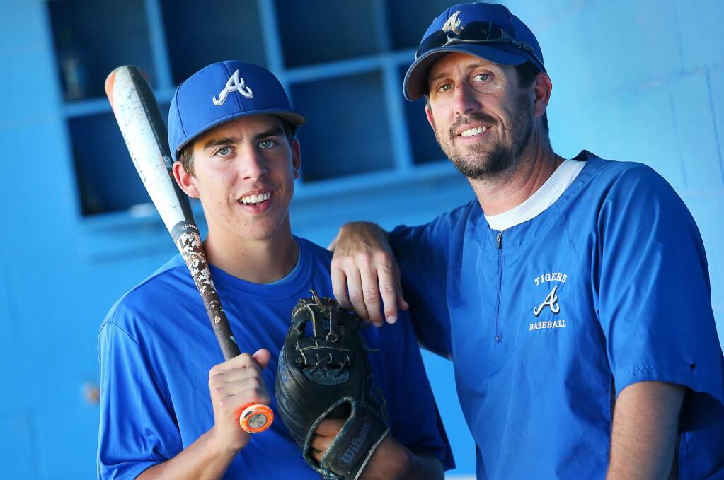 Jeff Ogston, right, is head coach of Analy baseball, where his son, Devon, is the starting shortstop and leadoff hitter. (Christopher Chung/ The Press Democrat)