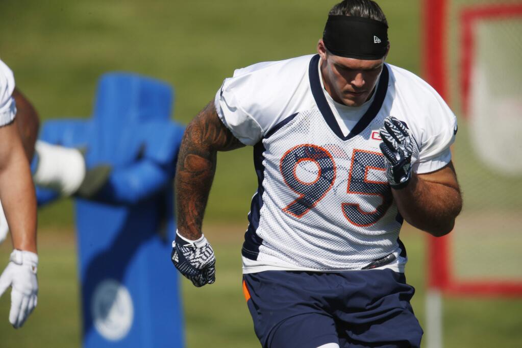 Denver Broncos defensive end Derek Wolfe takes part in drills during the team's NFL football training camp Tuesday, Aug. 16, 2016 in Englewood, Colo. (AP Photo/David Zalubowski)