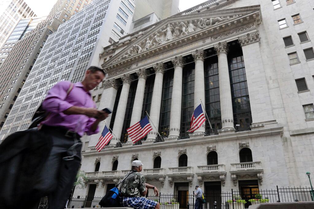 FILE - In this Friday, June 24, 2016, file photo, a man walks by the New York Stock Exchange. U.S. stock indexes were solidly higher in early trading Tuesday, June 28, 2016, as investors welcomed encouraging data on the economy and housing. The rebound followed even bigger gains in Europe as global markets recovered from a two-day rout triggered by Britain's vote to leave the European Union. (AP Photo/Richard Drew, File)