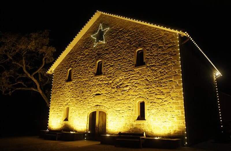 In this photo taken Wednesday, Nov. 30, 2011, the historic stone winery of Ehlers Estate is decorated with lights in St. Helena. (Eric Risberg / Associated Press)