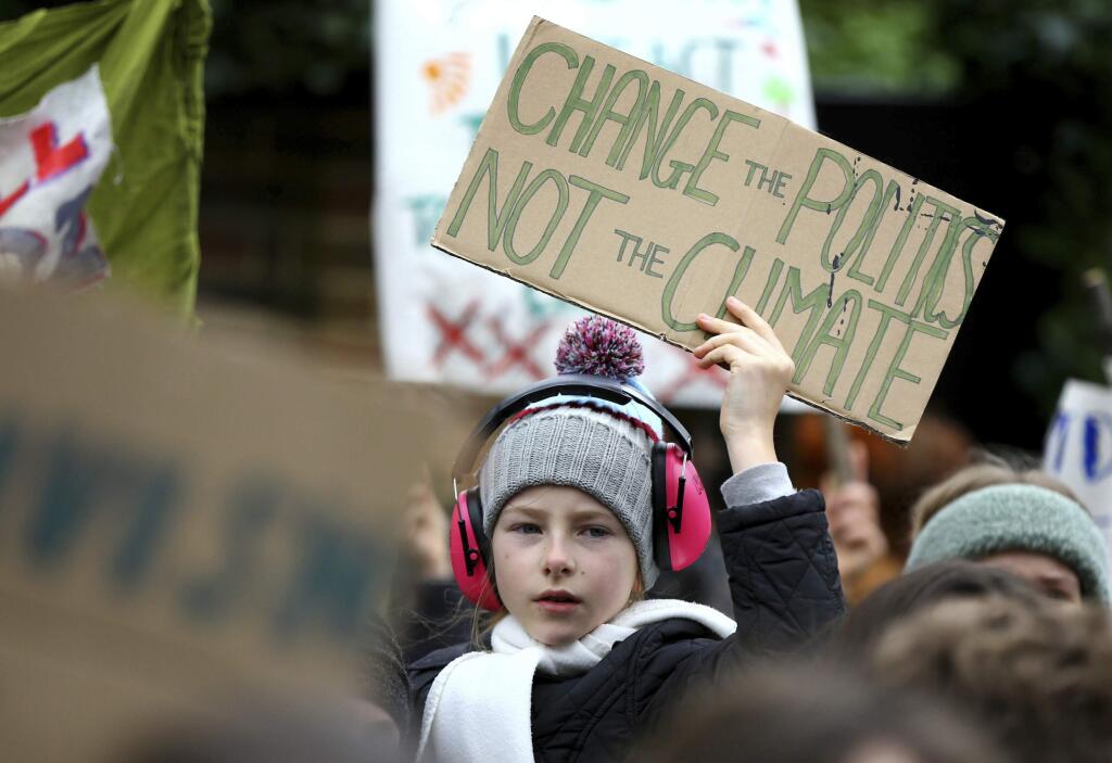 Students take part in a global school strike for climate change in Canterbury, south east England, Friday March 15, 2019. Students mobilized by word of mouth and social media skipped class Friday to protest what they believe are their governments' failure to take though action against global warming. (Gareth Fuller/PA via AP)