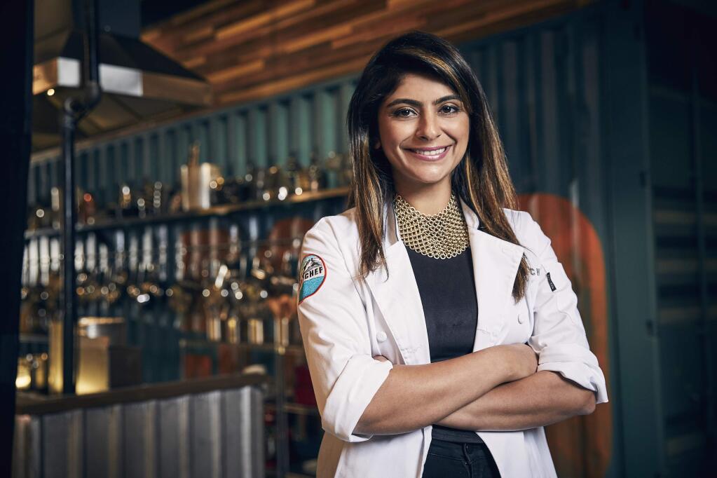 This May 9, 2017 photo released by Bravo shows cooking contestant Fatima Ali during season 15 of the competition series, 'Top Chef,' in Denver. Ali says she has a year to live. The 29-year-old underwent surgery to remove a tumor in January. However, Ali wrote Tuesday, Oct. 9, 2018, in an essay for Bon Appetit that the cancer is back. She says her oncologist told her she has a year to live, with or without the new chemotherapy regimen. (Tommy Garcia/Bravo via AP)
