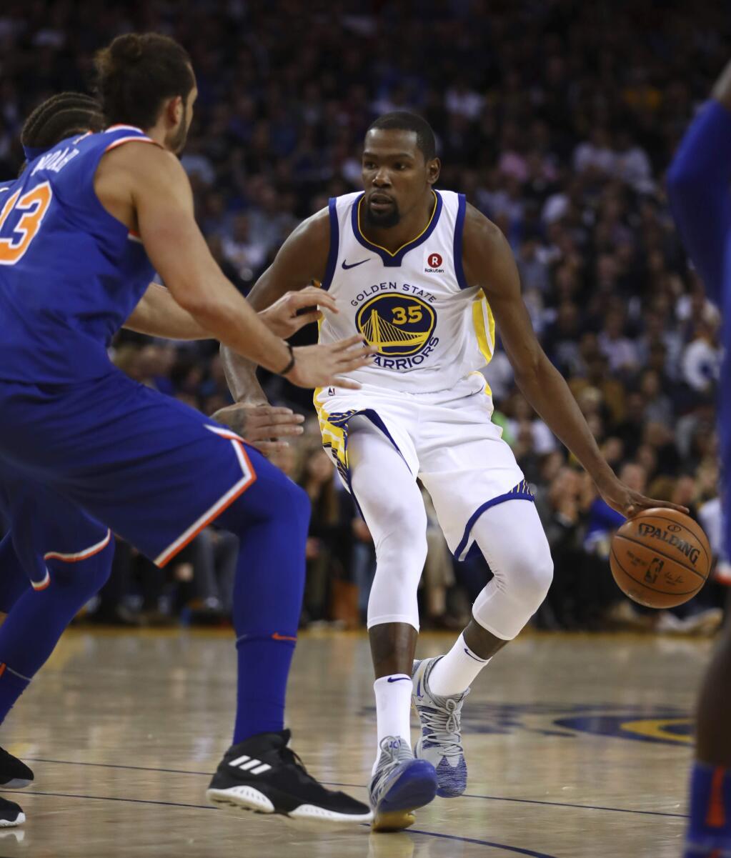 Golden State Warriors forward Kevin Durant, right, drives the ball against New York Knicks center Joakim Noah during the second half Tuesday, Jan. 23, 2018, in Oakland. (AP Photo/Ben Margot)