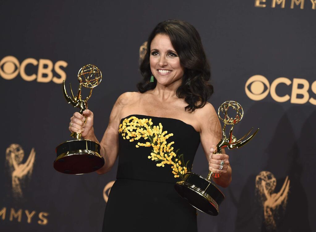 Julia Louis-Dreyfus poses in the press room with her awards for outstanding lead actress in a comedy series and outstanding comedy series for 'Veep' at the 69th Primetime Emmy Awards on Sunday, Sept. 17, 2017, at the Microsoft Theater in Los Angeles. (Photo by Jordan Strauss/Invision/AP)