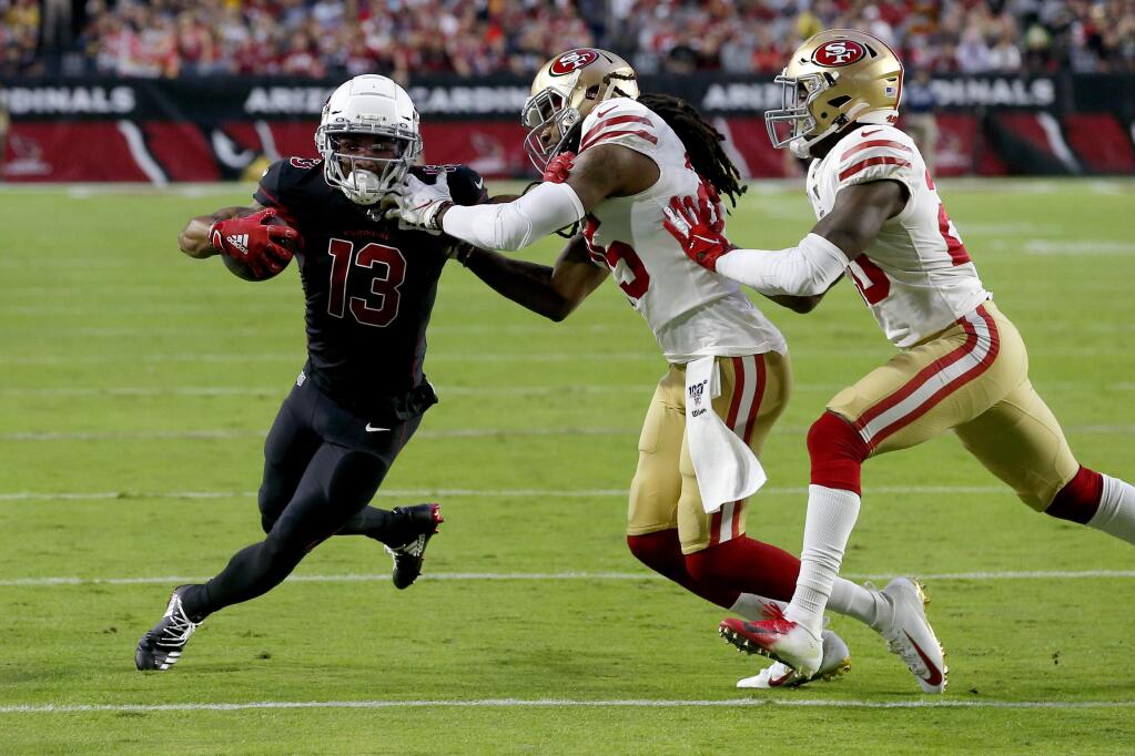 Arizona Cardinals wide receiver Christian Kirk, left, is tackled by San Francisco 49ers cornerback Richard Sherman during the first half, Thursday, Oct. 31, 2019, in Glendale, Ariz. (AP Photo/Rick Scuteri)