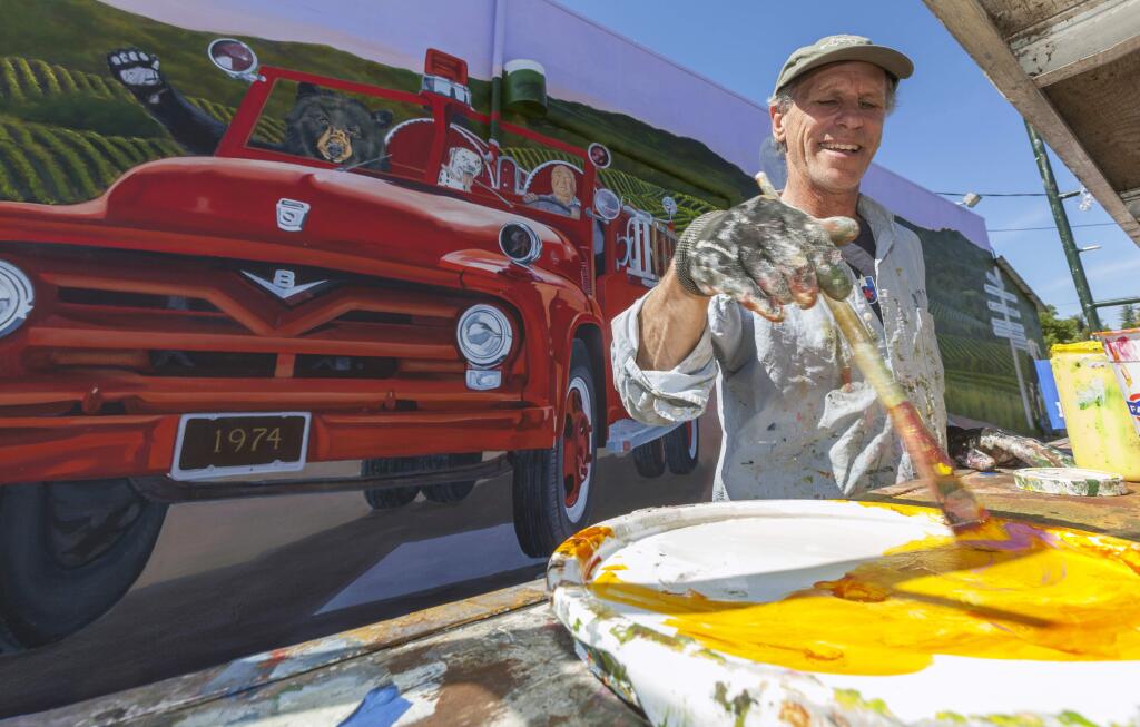 Sonoma County artist Dave Gordon puts the finishing touches on his Broadway Market mural. The artwork depicts the market's three owners – Alfred Robles, Ron Rodgers and Dianne Gaudino – as well as the late Mitch Mulas, former Fire Chief at Schell-Vista Fire Department, driving a fire truck. (Photos by Robbi Pengelly/Index-Tribune)