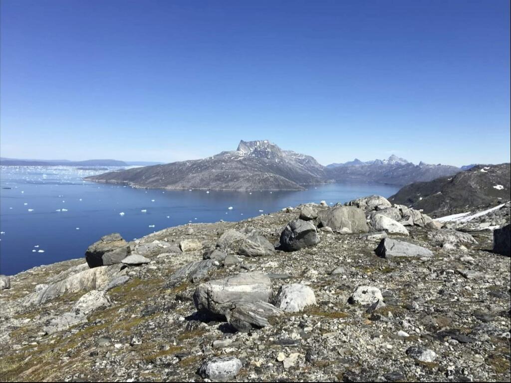 In this image taken on June 15, 2019 small pieces of ice float in the water in Nuuk Fjord, Greenland. Milder weather than normal in Greenland since the start of summer, led to the UN's weather agency voicing concern that the hot air which produced the recent extreme heat wave in Europe could be headed toward Greenland where it could contribute to increased melting of ice. (AP Photo/Keith Virgo)