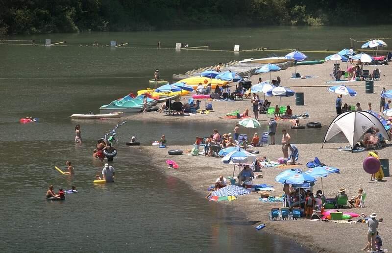 The Russian River attracts sunbathers, swimmers, waders and paddlers who flock to the beach and water at Johnson's Beach and Resort in Guerneville Wednesday July 23.