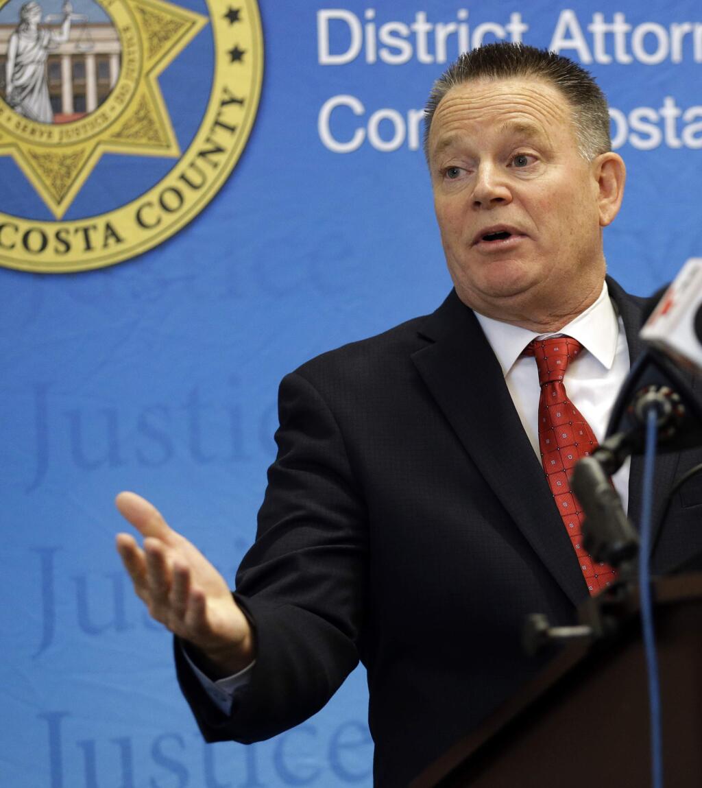 Contra Costa District Attorney Mark Peterson gestures while speaking at a media conference Friday, Nov. 4, 2016, in Martinez, Calif. Peterson said that he's charging a retired police captain with misdemeanor soliciting a prostitute, but found no other criminal conduct within his jurisdiction in a wide-ranging police sexual misconduct case involving more than two dozen officers. (AP Photo/Ben Margot)
