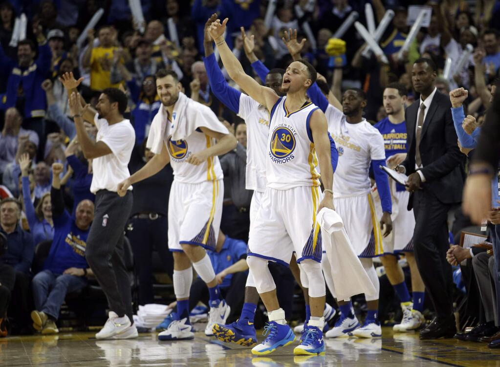 Golden State Warriors' Stephen Curry (30) celebrates with teammates as his team jumps ahead of the Oklahoma City Thunder during the second half Thursday, March 3, 2016, in Oakland. Golden State won 121-106. (AP Photo/Marcio Jose Sanchez)