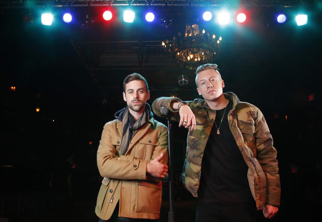 FILE - In this Nov. 20, 2012 file photo, American musician Ben Haggerty, better known by his stage name Macklemore, right, and his producer Ryan Lewis pose for a portrait at Irving Plaza in New York. Macklemore & Ryan Lewis are top contenders at the Grammy Awards on Sunday, Jan. 26, 2014, with seven nominations, including best new artist and song of the year for ìSame Love.î Their debut album, ìThe Heist,î is up for album of the year and best rap album, while the massive hit ìThrift Shopî is nominated for best rap song and rap performance. The duoís other hit, ìCanít Hold Us,î will compete for best music video. (Photo by Carlo Allegri/Invision/AP, File)