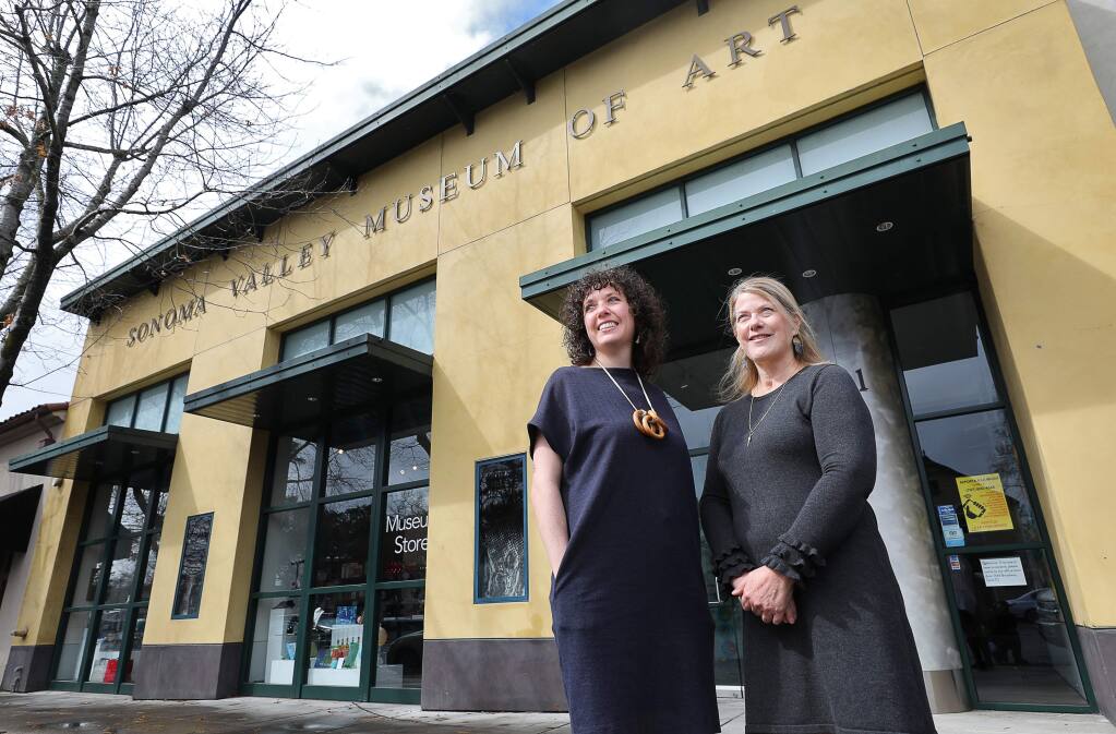 Tanya Gayer, left, exhibitions manager, and Margie Maynard, deputy director of engagement and exhibitions, co-curated the Sonoma Valley Museum of Art's exhibit devoted to the 2017 wildfires. (Christopher Chung/ The Press Democrat)