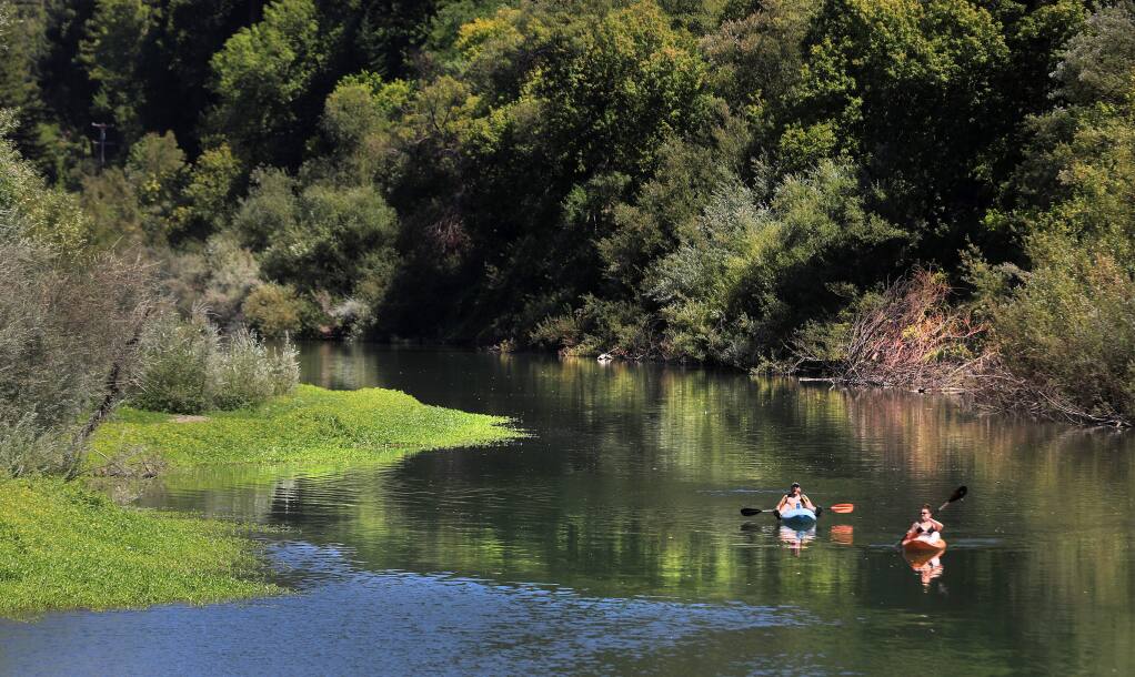 Kayakers float down the Russian River near the Odd Fellows Park summer crossing in Guerneville on Thursday, Aug. 15, 2019 in Guerneville. (KENT PORTER/ PD)