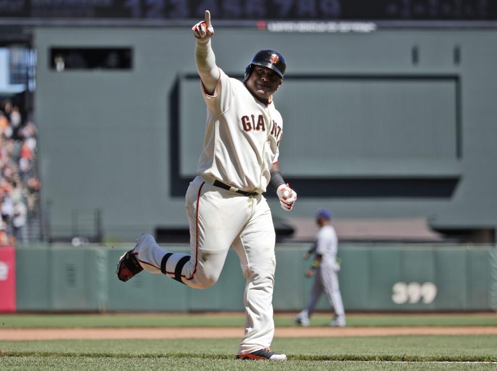 San Francisco Giants' Pablo Sandoval celebrates as he rounds the bases following his two-run home run against the Milwaukee Brewers during the fifth inning of a baseball game on Sunday, Aug. 31, 2014, in San Francisco. (AP Photo/Marcio Jose Sanchez)