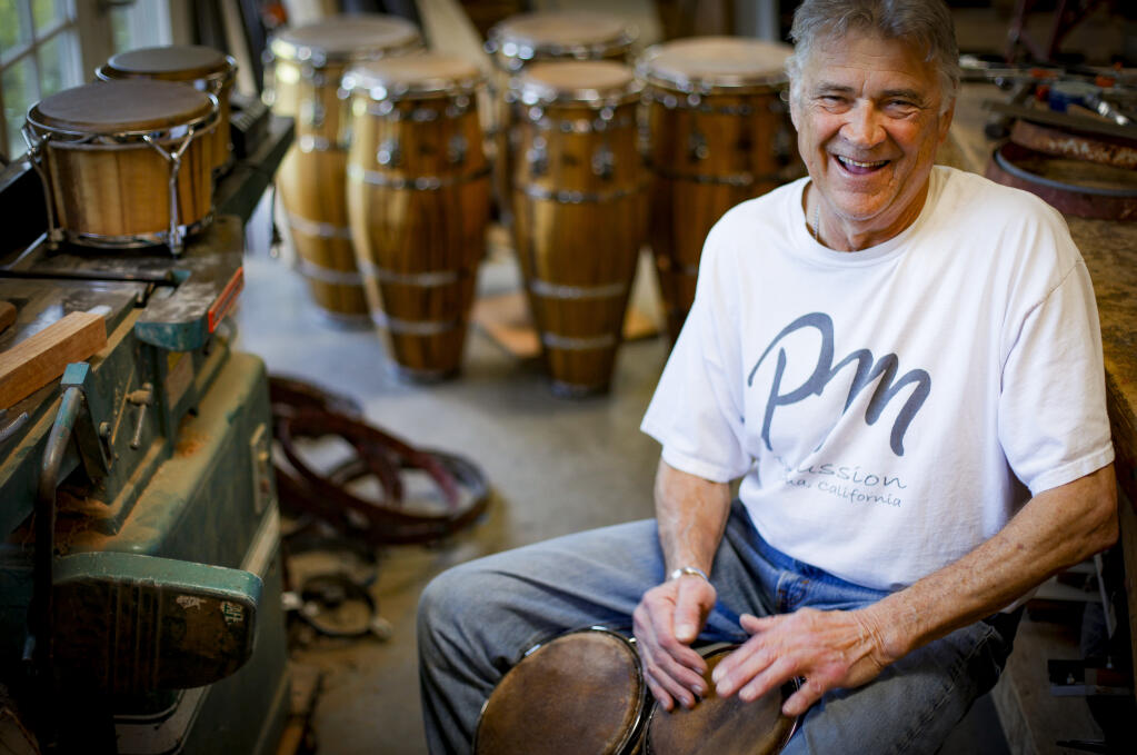 Peter Musser plays on bongos that he handmade in his garage in Petaluma where he operates PM Percussion. Following his passion for music and crafting with his hands, he started making drums in 2002. Photographed on Tuesday, March 25, 2024. (CRISSY PASCUAL/ARGUS-COURIER STAFF)