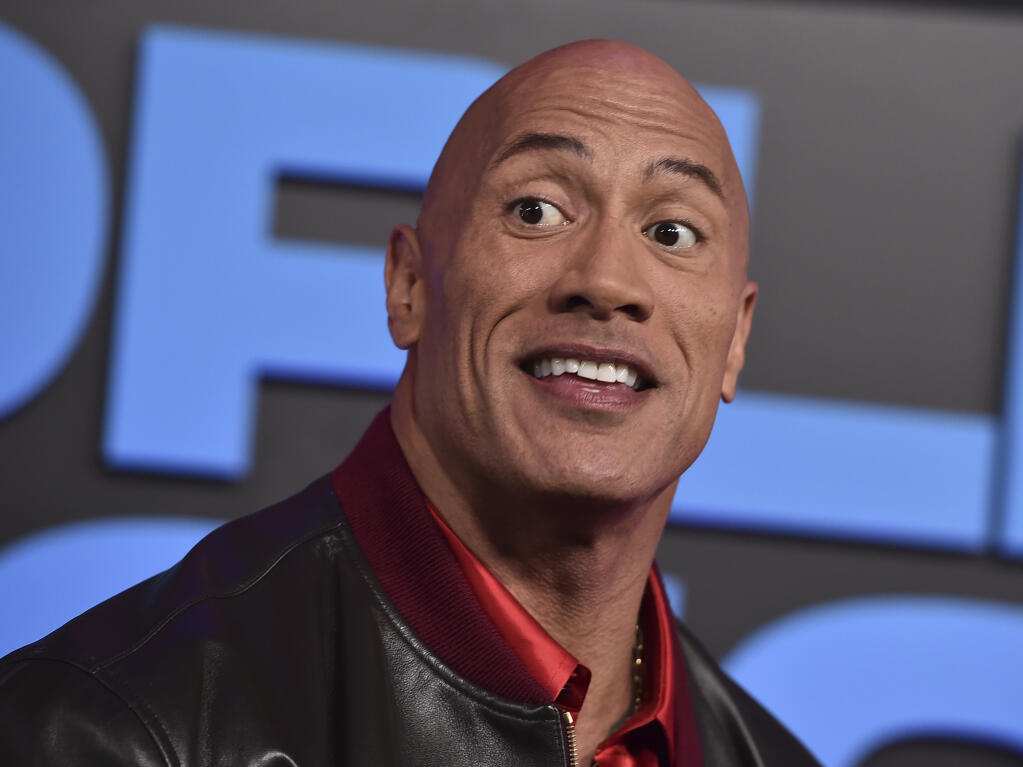 Dwayne Johnson is rethinking his prior support of Joe Rogan after learning that the controversial podcast host repeatedly used the N-word on his show. (Photo by Jordan Strauss/Invision/AP)